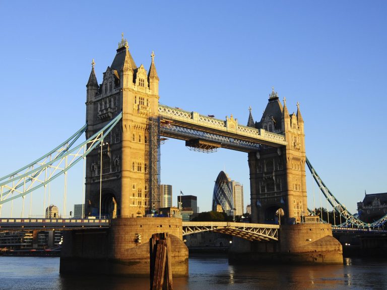 Tower Bridge with blue skies in the background and the city skyline visible beyond.